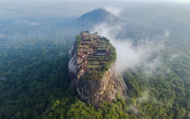 Drone photograph capture the mighty Sigiriya Lion's Rock in all its glory on October 8, 2022. Tourists on top of the 180 metre (590ft) high UNESCO World Heritage Site look tiny in comparison to the sheer size of the fifth century fortress. Photographer Azim Khan Ronnie flew his drone up to 500 metres (1,640ft) in the air to capture Lion's Rock, which is near Dambulla in Sri Lanka. (Photo by Azim Khan Ronnie/Solent News & Photo Agency/Rex Features/Shutterstock)