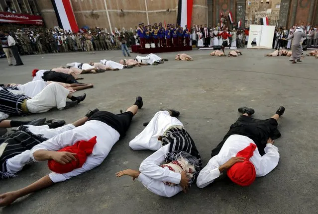 Houthi followers lie on the ground to represent civilian victims of Saudi-led air strikes during a ceremony marking the first anniversary of the Houthi movement's takeover of Yemen's capital Sanaa September 21, 2015. (Photo by Khaled Abdullah/Reuters)