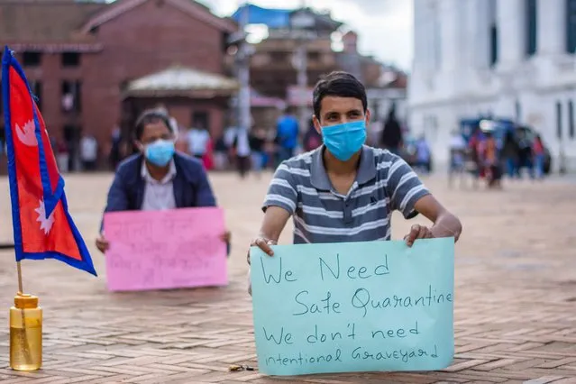 A youth holds a play card in a protest against government demanding better response to fight against coronavirus disease at Kathmandu, Nepal on Monday, July 6, 2020. (Photo by Rojan Shrestha/NurPhoto via Getty Images)