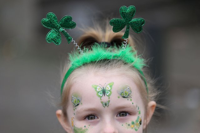 A girl displays shamrock decoration during the St Patrick's Day Parade in Manchester, on March 16, 2025. (Photo by Temilade Adelaja/Reuters)