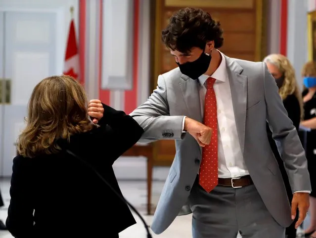 Chrystia Freeland, Canadian deputy prime minister, elbow bumps Canadian Prime Minister Justin Trudeau after she is sworn in as finance minister at Rideau Hall in Ottawa, Ontario, Canada on August 18, 2020. (Photo by Patrick Doyle/Reuters)