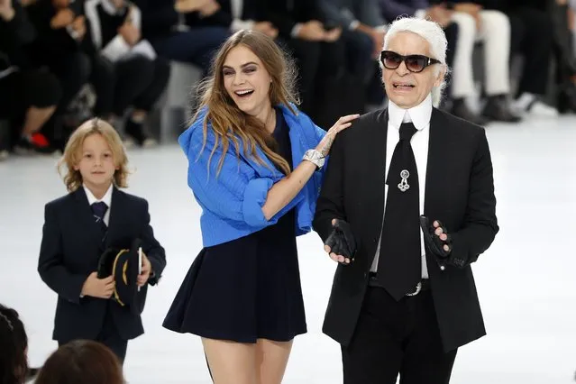 German designer Karl Lagerfeld (R) and model Cara Delevingne (C) appear at the end of his Spring/Summer 2016 women's ready-to-wear collection for fashion house Chanel at the Grand Palais which is transformed into a Chanel airport during the Fashion Week in Paris, France, October 6, 2015. (Photo by Charles Platiau/Reuters)