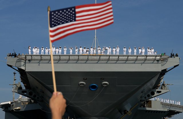 US sailors stand on the deck of the USS Gerald R. Ford as they wait for the aircraft carrier to leave Norfolk, Virginia, on Tuesday, June 24, 2025. They were leaving for a scheduled deployment. (Photo by Joe Raedle/Getty Images)