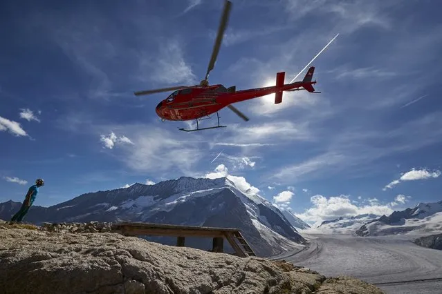 A helicopter takes off after delivering supplies to the Konkordia Hut near the Aletsch Glacier, Switzerland, August 28, 2015. (Photo by Denis Balibouse/Reuters)