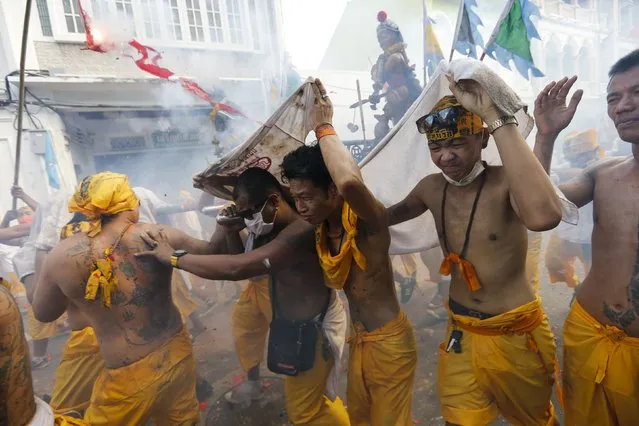 Devotees of the Chinese Ban Tha Rue shrine reacts as fire crackers explode during a procession celebrating the annual vegetarian festival in Phuket, Thailand, October 17, 2015. (Photo by Jorge Silva/Reuters)