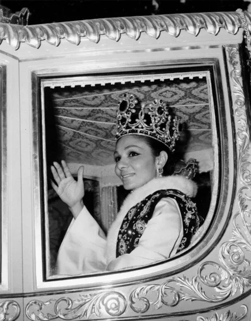 Empress Farah, wife of the Shah of Iran, is pictured wearing her crown as she waves to crowds while driving through the streets of Tehran, October 26, 1967, following their coronation ceremony. (Photo by AP Photo/Stringer)