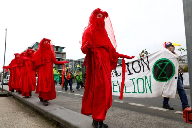 Extinction Rebellion activists take part in a protest in Berlin, Germany on October 5, 2020. (Photo by Michele Tantussi/Reuters)