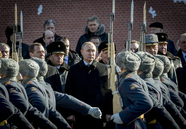 (From 2ndL) Russian Prime Minister Dmitry Medvedev, Russian President Vladimir Putin and Defence Minister Sergey Shoygu attend a wreath laying ceremony at the Tomb of the Unknown Soldier near the Kremlin wall to mark Defender of the Fatherland Day in Moscow on February 23, 2018. Defender of the Fatherland Day, celebrated in Russia on February 23, honours the nation's army and is a nationwide holiday. (Photo by Yuri Kadobnov/AFP Photo)