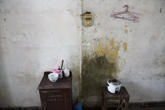 A rice cooker and other possessions belonging to Wang Xinglong are seen in his room at Yangjia Hospital in Wuyi County, Zhejiang Province, China October 19, 2015. Wang, who was diagnosed with pneumoconiosis as a young man, spends ten days every year at the hospital having health checks. (Photo by Damir Sagolj/Reuters)