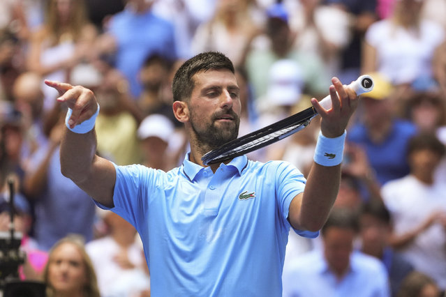 Novak Djokovic, of Serbia, pretends to play the violin after defeating Zachary Svajda, of the United States, during the second round of the U.S. Open tennis championships, Wednesday, August 27, 2025, in New York. (Photo by Kirsty Wigglesworth/AP Photo)