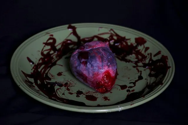 A bloody heart made of gummy candy and red jelly is pictured at the Zombie Gourmet homemade candy manufacturer on the outskirts of Mexico City October 30, 2015. A candy maker in Mexico is raising the stakes this Halloween when it comes to spooky with chewable candy ears and an edible candy foetus for the ultimate prankster. (Photo by Carlos Jasso/Reuters)