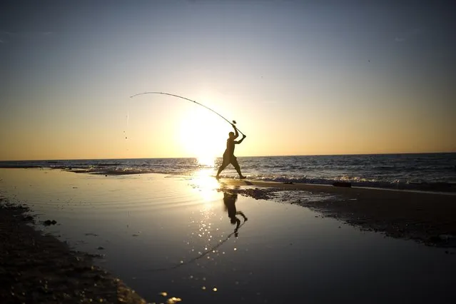 A man casts his fishing line in the Mediterranean Sea on Zikim beach, near Ashkelon November 30, 2014. (Photo by Amir Cohen/Reuters)