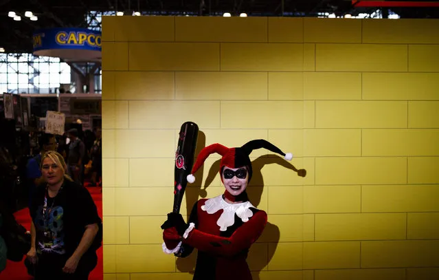 A woman dressed as the character “Harley Quinn” from the Batman series, poses for a portrait during the 2016 New York Comic Con at the Jacob K. Javits Convention Center in New York, New York, USA, 06 October 2016. The annual event offers pop culture fans exhibitors and displays of popular video games, movies and comic books and many people attending dress as their favorite character. (Photo by Justin Lane/EPA)