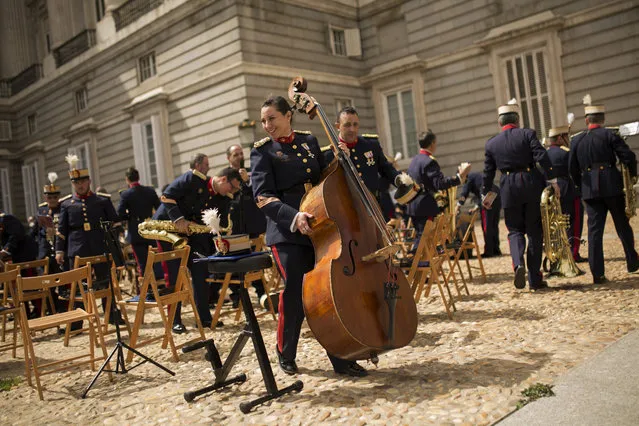 A member of the Royal Guard music band holds a double bass after playing outside the Royal Palace in Madrid, Wednesday, April 4, 2018. (Photo by Francisco Seco/AP Photo)