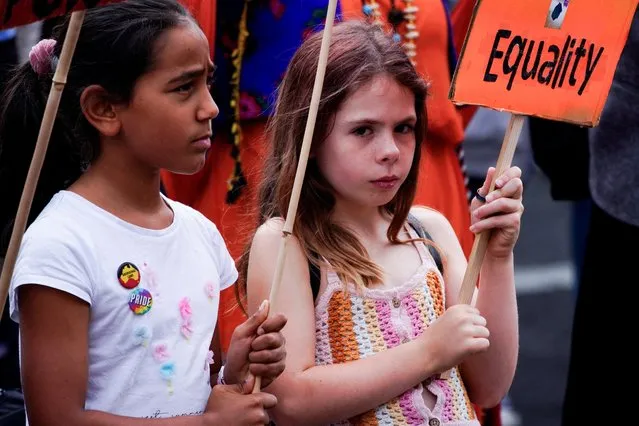Children participate in an International Women's Day demonstration, in Melbourne, Australia on March 8, 2023. (Photo by Sandra Sanders/Reuters)