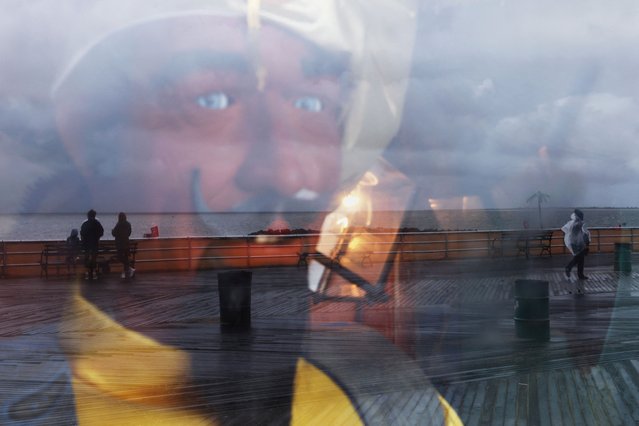 People are reflected in an arcade machine during Hurricane Erin, the first hurricane of the 2025 Atlantic season, along the boardwalk at Coney Island beach in the Brooklyn borough of New York City, U.S., August 20, 2025. (Photo by Shannon Stapleton/Reuters)