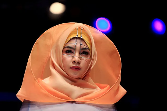 A model presents creations by student designer Sherly Az Zahra on the first day of the Indonesia Muslim Fashion Festival in Jakarta, Indonesia, April 19, 2018. (Photo by Reuters/Beawiharta)