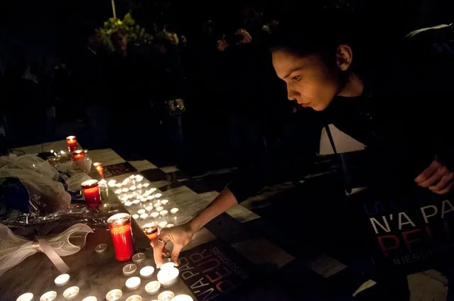 Greeks pay tribute to victims of the Paris attacks, in front of the French consulate in Thessaloniki, Greece, November 14, 2015. (Photo by Alexandros Avramidis/Reuters)