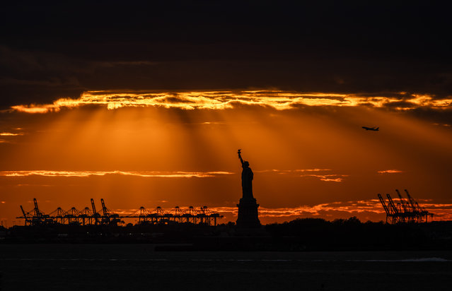 The Statue of Liberty stands in New York Harbor on October 22, 2025 in New York City. Numerous vendors were arrested in a raid by federal agents from Immigration and Customs Enforcement (ICE). The raid and arrests, which the government said were related to the selling of counterfeit goods, resulted in protests against the detention of the individuals, many of whom are of African descent. (Photo by Spencer Platt/Getty Images)