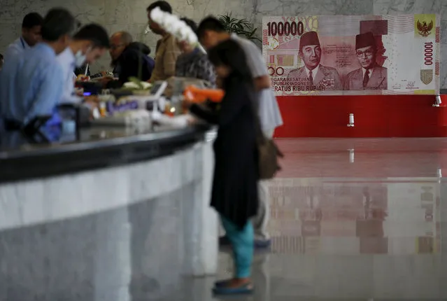 Customers are seen at a counter inside the Bank Indonesia complex in Jakarta, Indonesia, December 16, 2015. (Photo by Darren Whiteside/Reuters)