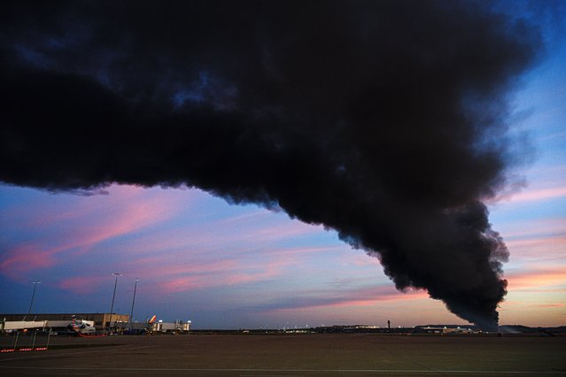 A plume of black smoke fills the sky, caused from a crash of a UPS cargo plane at the international airport in Louisville, Ky., November 4, 2025. (Photo by Jon Cherry/AP Photo)