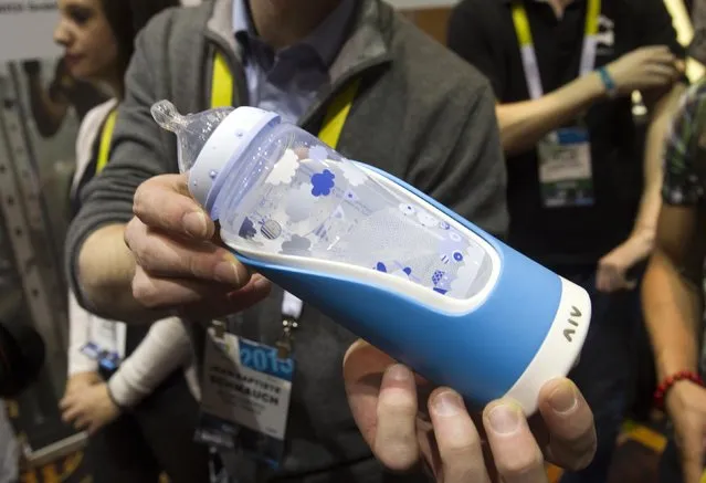A baby bottle with a GlGl bottle holder is displayed during the 2015 International Consumer Electronics Show (CES) in Las Vegas, Nevada January 4, 2015. The holder sends a variety of information to a parent's smart phone and can help reduce colic by finding the optimal feeding angle, a representative said. (Photo by Steve Marcus/Reuters)