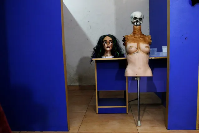 A mannequin is placed near a table after being created for a Halloween film project in a art studio in Victoria Island, Lagos, Nigeria October 28, 2016. (Photo by Akintunde Akinleye/Reuters)
