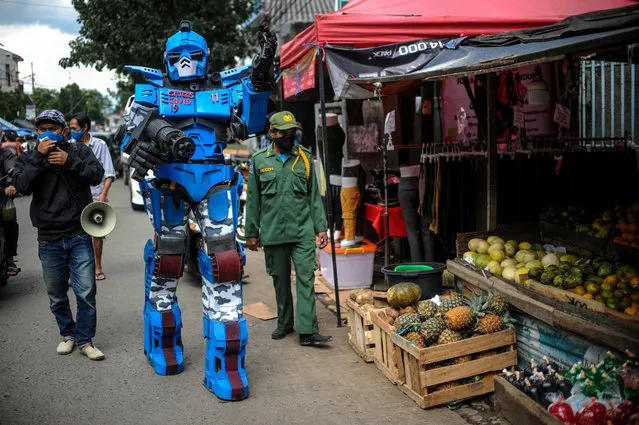 A man wearing a Transformers costume appeals to the citizens to stay at a home amid coronavirus disease (COVID-19) outbreak, in Bandung, West Java Province, Indonesia, May 4, 2020. (Photo by Raisan Al Farisi/Antara Foto via Reuters)