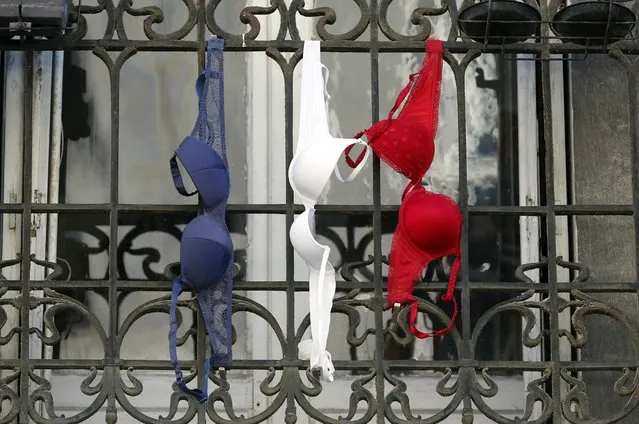 Blue, white and red brassieres, the colours of the French national flag, hang from a balcony in Marseille, France, November 27, 2015 as the French President called on all French citizens to hang the tricolour national flag from their windows on Friday to pay tribute to the victims of the Paris attacks during a national day of homage. (Photo by Jean-Paul Pelissier/Reuters)