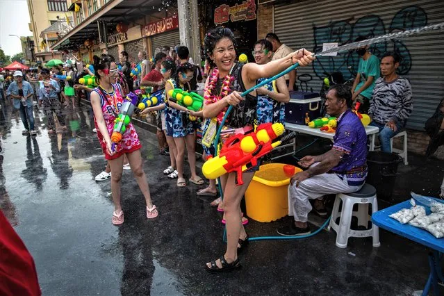Festival goers take part in a massive water gun fight during Songkran on Khaosan Road on April 13, 2023 in Bangkok, Thailand. (Photo by Lauren DeCicca/Getty Images)