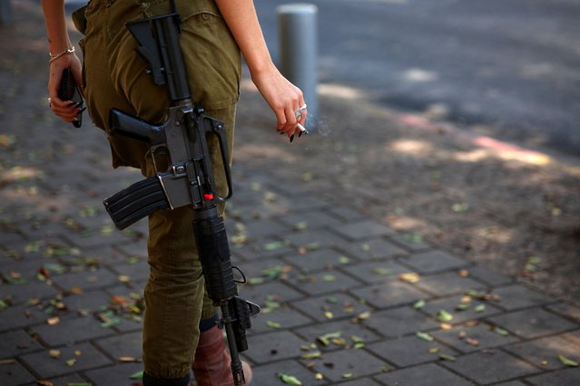 An Israeli soldier waits at the bus station, amid the ongoing conflict in Gaza between Israel and Hamas, in Tel Aviv, Israel on August 15, 2024. (Photo by Florion Goga/Reuters)