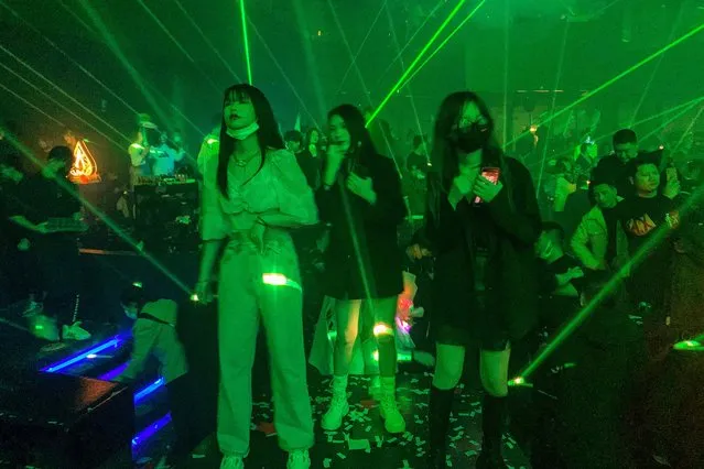 In this picture taken on January 21, 2021, people visit a nightclub in Wuhan, China's central Hubei province. (Photo by Hector Retamal/AFP Photo)