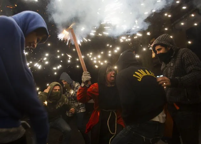 People take part in the traditional festival of “Correfoc” in Palma de Mallorca, on January 17, 2015. (Photo by Jaime Reina/AFP Photo)