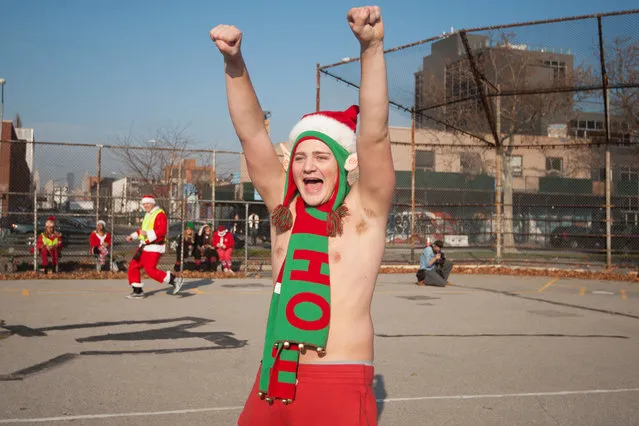 A man dressed as a Santa's elf pumps his fists during a kickball game before the start of the annual SantaCon pub crawl December 12, 2015 in the Brooklyn borough of New York City. (Photo by Stephanie Keith/Getty Images)