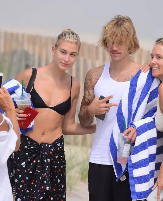 Justin Bieber and Hailey Baldwin were spotted enjoying a mini vacation for Independence Day, as the duo enjoy the week in The Hamptons, USA on July 3, 2018. On Tuesday, they headed to the beach for a romantic picnic. Hailey showed off her amazing bikini body, as Justin relaxed in a white tank top. They brought towels, Starbucks and some snacks as they sat together laughing and enjoying each other's company. They walked together back to their car without going in the water which was a bit chilly. They're staying at the $50m residence of Hampton's Real Estate Mogul, Joe Farrell, who has hosted Jay Z and Beyonce previously. (Photo by 247PAPS.TV/Splash News and Pictures)