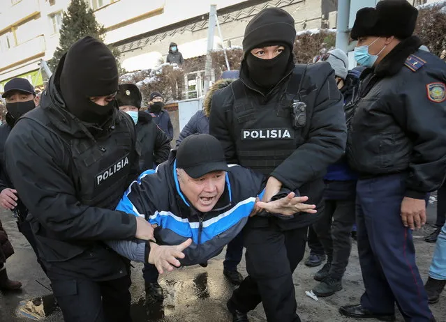 Law enforcement officers detain a man during a protest denouncing what the opposition supporters called political repression, in Almaty, Kazakhstan on February 28, 2021. (Photo by Pavel Mikheyev/Reuters)