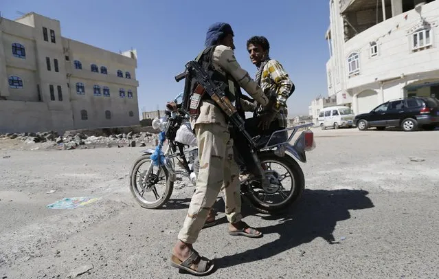 A Houthi fighter in military uniform checks a motorcyclist at a checkpoint in Sanaa January 27, 2015. Yemen's President Abd-Rabbu Mansour Hadi and his government quit on last Thursday in a confrontation with Houthi militiamen, an Iranian-allied armed group, depriving Washington of a staunch ally in its campaign against al Qaeda in the Arabian Peninsula (AQAP). (Photo by Khaled Abdullah/Reuters)