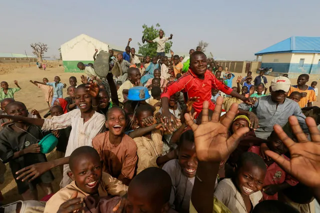 Children react as they gather for the arrival of the rescued JSS Jangebe schoolgirls in Jangebe, Zamfara, Nigeria on March 3, 2021. (Photo by Afolabi Sotunde/Reuters)