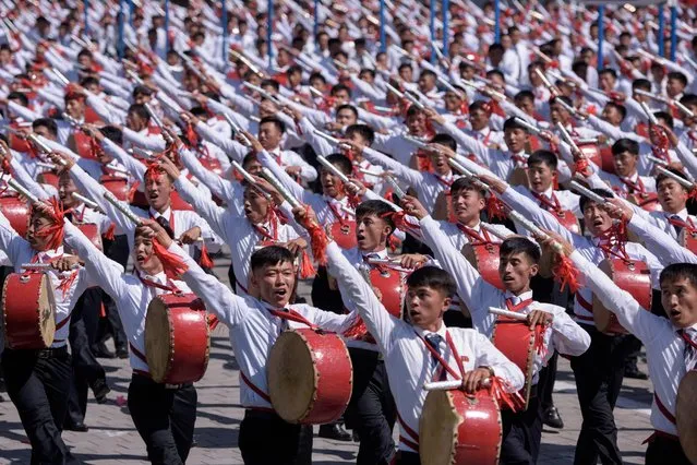 Students march past a balcony from where North Korea' s leader Kim Jong Un was watching, during a mass rally on Kim Il Sung square in Pyongyang on September 9, 2018. (Photo by Ed Jones/AFP Photo)