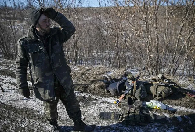 A Ukrainian serviceman reacts as he leaves Debaltseve, eastern Ukraine, near Artemivsk February 18, 2015. (Photo by Gleb Garanich/Reuters)