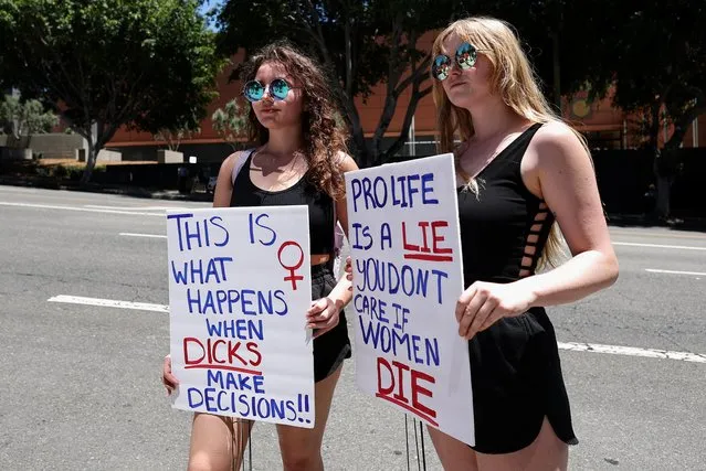 Abortion rights protesters hold signs as they demonstrate after the U.S. Supreme Court ruled in the Dobbs v Women’s Health Organization abortion case, overturning the landmark Roe v Wade abortion decision in Los Angeles, California, U.S., June 24, 2022. (Photo by Lucy Nicholson/Reuters)