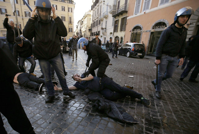 Italian policemen clash with Feyenoord's fans at the Spanish steeps, in downtown Rome, prior to the Europa League soccer match between Roma and Feyenoord, Thursday, February 19, 2015. (Photo by Gregorio Borgia/AP Photo)