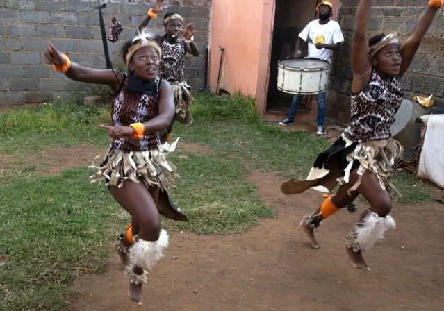 A group of girls perform traditional Zulu dance in the yard of a home in the Orange Farm Township south of Johannesburg, Wednesday, April 14, 2021. Amid the classes in dancing and marimba music, a leader of the culture group praised Britain's Prince Philip, who died last week and whose Duke of Edinburgh Awards helped to fund the culture group's activities. (Photo by Denis Farrell/AP Photo)