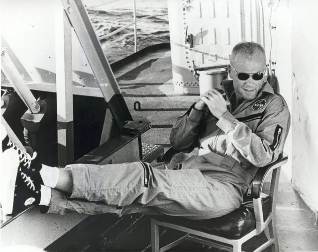 Astronaut John Glenn relaxes aboard the USS Noa after being recovered from the Atlantic near Grand Turk Island following Glenn's first orbit around the Earth on February, 20, 1962. The Noa picked him up 21 minutes after impact. (Photo by Reuters/NASA)