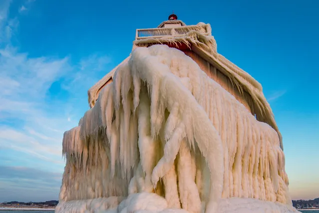 Impressive ice formations on the front of the Grand Haven lighthouse. (Photo by Mike Kline/Barcroft Media)