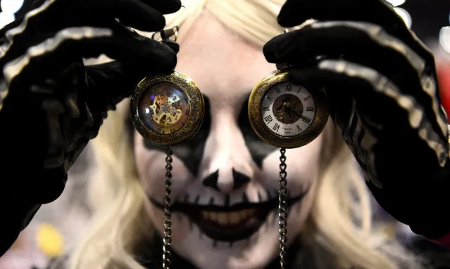 A cosplayer brandishes pocket watches at the MCM London Comic Con at the Excel Centre in London, Britain October 26, 2018 – a reminder of the end of Daylight Saving Time on 29 October. (Photo by Kirsty O’Connor/PA Wire)