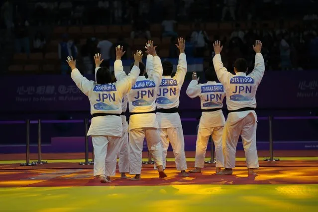 Members of team Japan celebrate after winning gold medal in the mixed team judo final between Uzbekistan and Japan at 19th Asian Games in Hangzhou, China, Wednesday, September 27, 2023. (Photo by Aijaz Rahi/AP Photo)