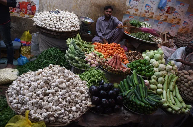 A Pakistani vendor waits for customers at a vegetable roadside shop in Karachi on September 26, 2018. (Photo by Rizwan Tabassum/AFP Photo)