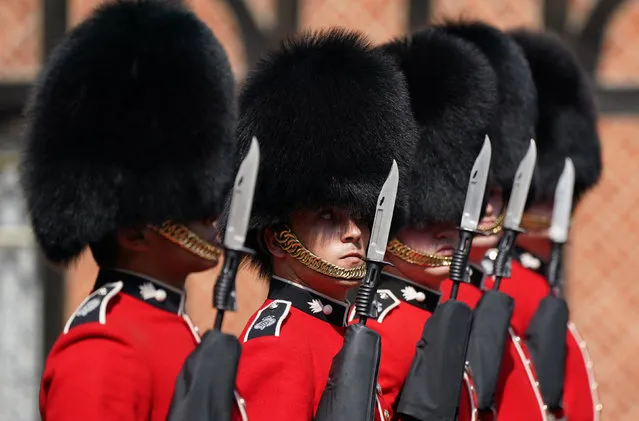 Members of the 1st Battalion Grenadier Guards participate in the Changing of the Guard at Windsor Castle in Berkshire, south east England on July 22, 2021, which is taking place for the first time since the start of the Covid-19 pandemic. (Photo by Andrew Matthews/Pool via AFP Photo)