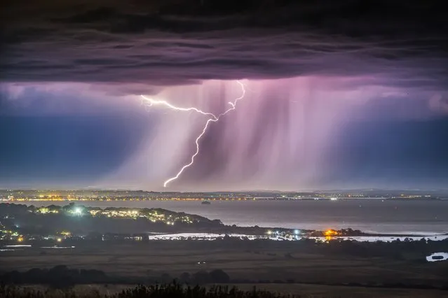Dramatic thunder and lightning striking Portsmouth in Hampshire, South East England last night, July 9, 2023, captured from the Isle of Wight. (Photo by Jamie Russell/Bournemouth News)